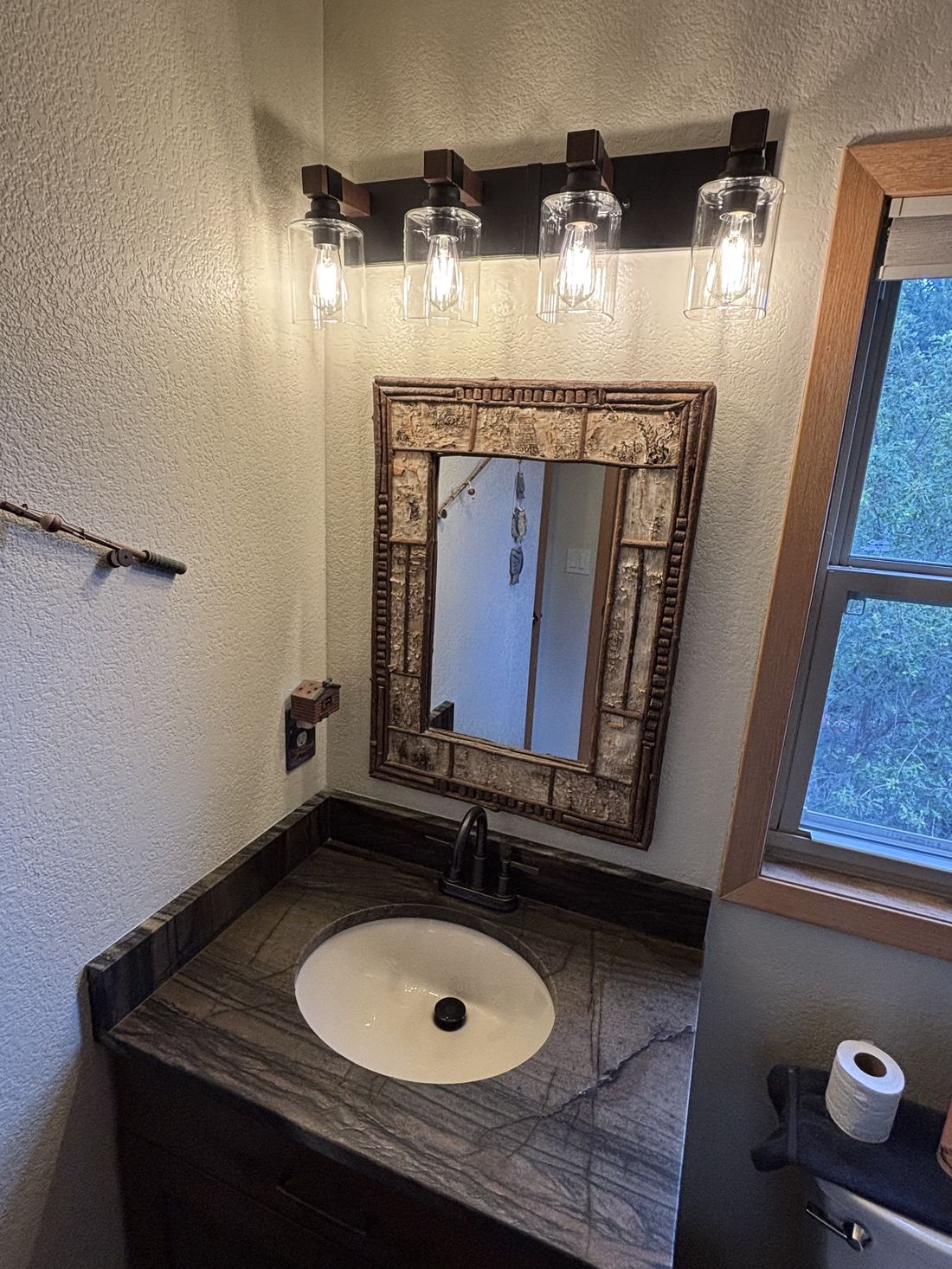 Bathroom vanity lighting fixtures installed above a stone countertop
