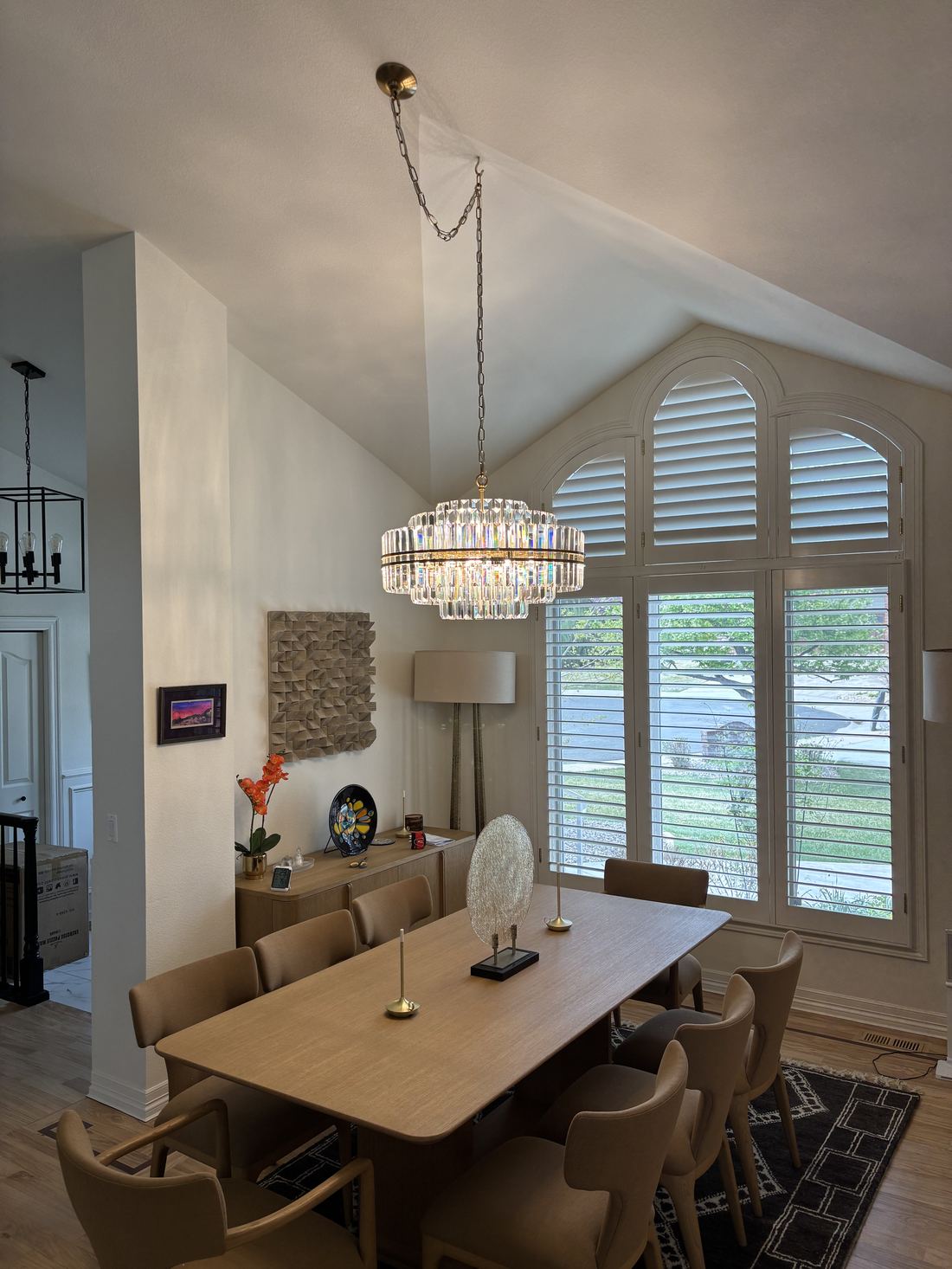 Crystal chandelier installed in a vaulted dining room