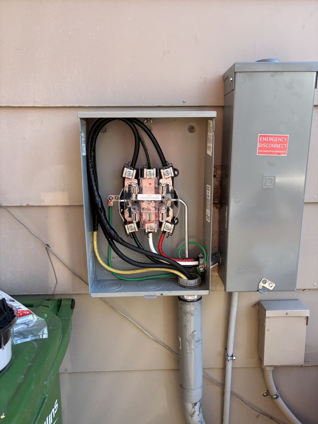 Opened meter base showing new service entrance wiring